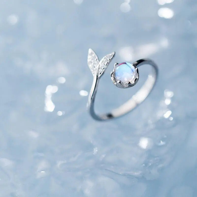 Adjustable ring with dolphin tail made of sterling silver and blue zirconium dioxide