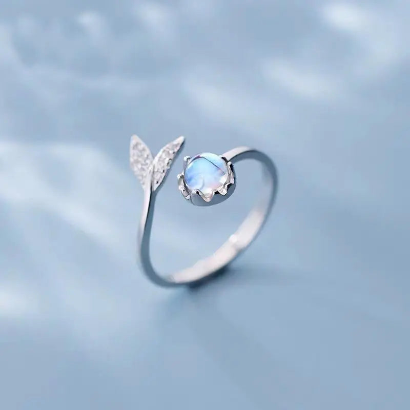 Adjustable ring with dolphin tail made of sterling silver and blue zirconium dioxide